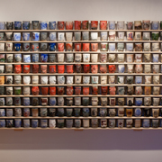 A wall of ceramic cups by artist Ehren Tool.