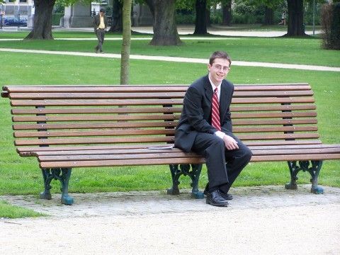 Alex on a park bench in Brussels