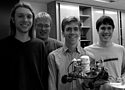 Robotics Team members Steve Meisburger '07, Bret Jackson '08, George Kachergis '07, and Will Camisa '07 smile with one of their robots.