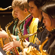 Close-up image of three saxophone players in the Carleton Jazz Ensemble.