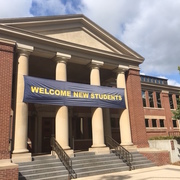 Image of the front of Sayles Hill Campus Center with a "Welcome New Students" banner.