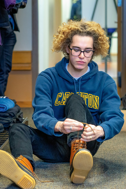 Student tying boots