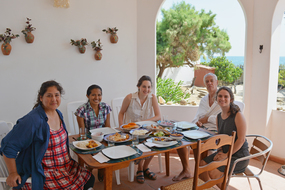 Constanza Ocampo-Raeder, left, enjoys a meal with her students in Peru.